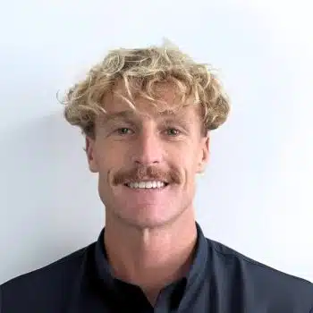 Portrait of David Pearce, Consulting Psychologist at Mind-Care Mental Health Services, wearing a dark collared shirt against a plain white background.