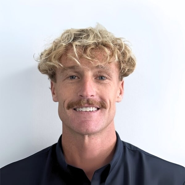 Portrait of David Pearce, Consulting Psychologist at Mind-Care Mental Health Services, wearing a dark collared shirt against a plain white background.